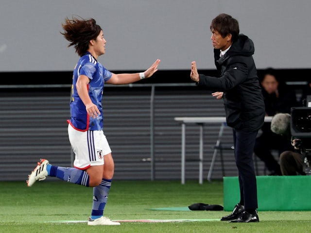 Japan's Hana Takahashi celebrates scoring their first goal with Women's coach Futoshi Ikeda on February 28, 2024