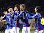Japan's Ao Tanaka celebrates scoring their first goal with Hidemasa Morita and teammates on March 21, 2024