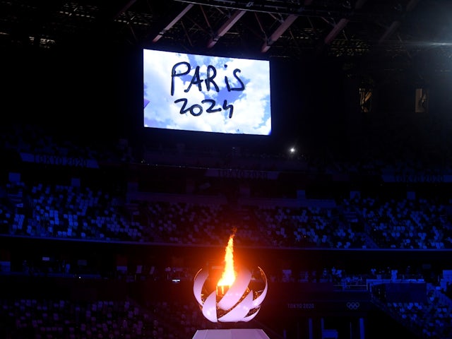 The Olympic torch and cauldron are seen with Paris 2024 displayed on the big screen during the Tokyo 2020 closing ceremony on August 8, 2021