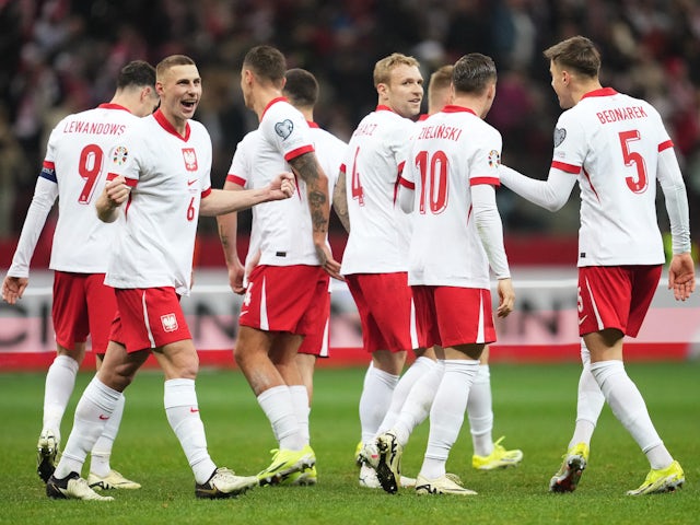 Poland's Jakub Piotrowski celebrates scoring their third goal with teammates on March 21, 2024