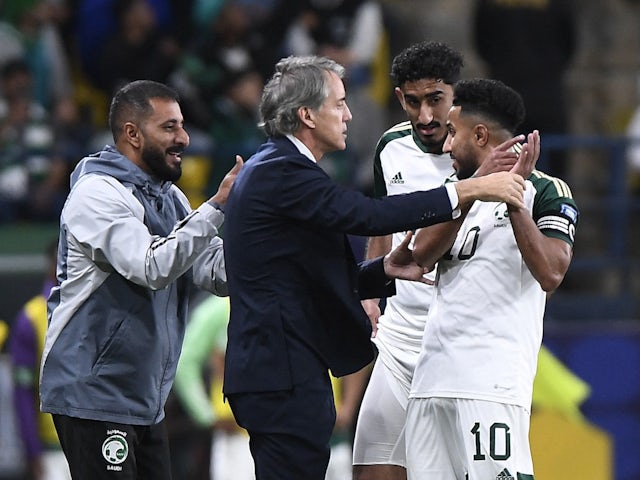 Saudi Arabia's Salem Al Dawsari celebrates scoring their first goal with Roberto Mancini on March 21, 2024