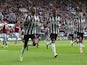 Newcastle United's Alexander Isak celebrates scoring their first goal with Joe Willock on March 30, 2024