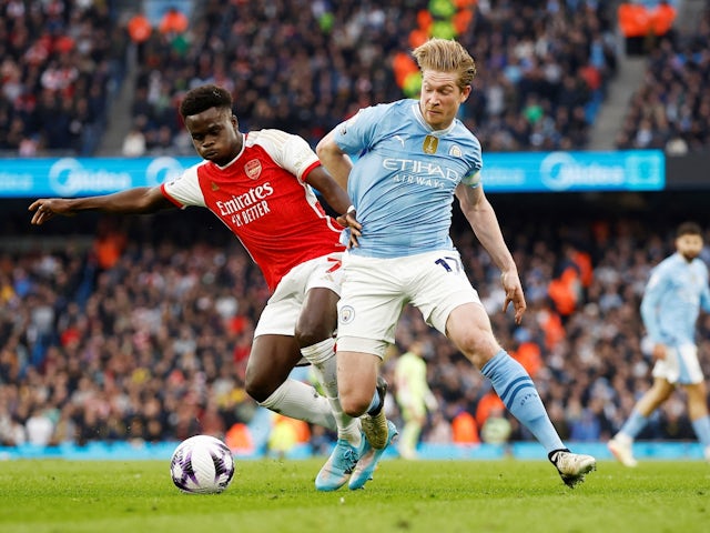 Arsenal's Bukayo Saka in action with Manchester City's Kevin De Bruyne on March 31, 2024