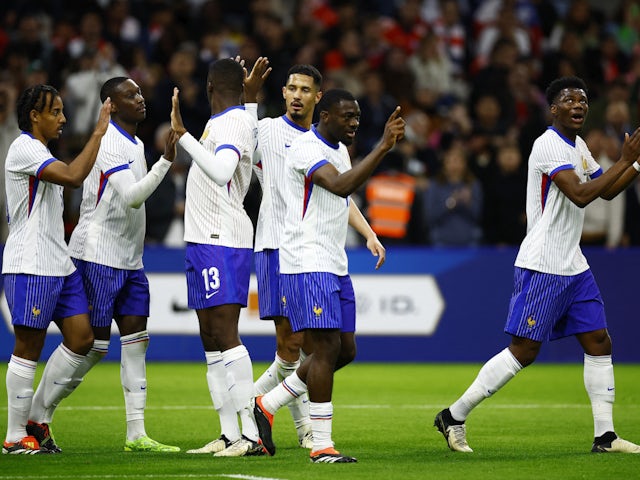 France's Randal Kolo Muani celebrates scoring their second goal with teammates on March 26, 2024