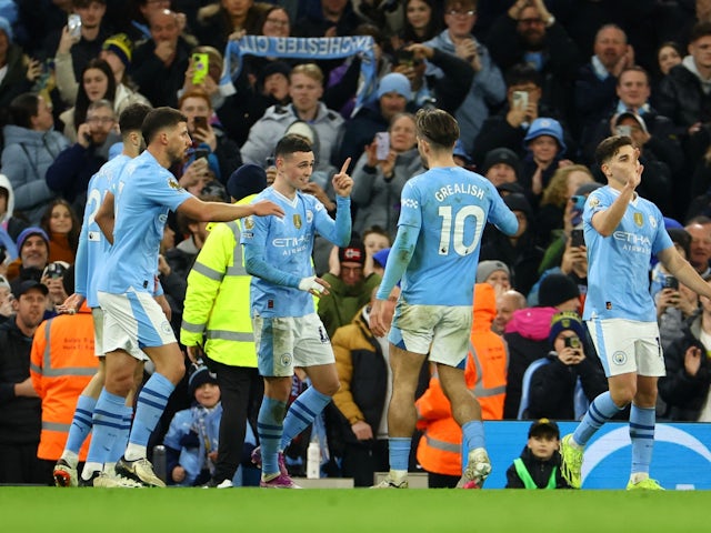 Manchester City's Phil Foden celebrates scoring their third goal with Ruben Dias and Jack Grealish on April 3, 2024