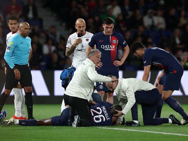Paris Saint-Germain's (PSG) Nordi Mukiele receives medical attention after sustaining an injury on April 6, 2024