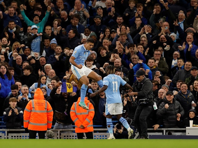 Manchester City's Rodri celebrates scoring their first goal with Jeremy Doku on April 3, 2024