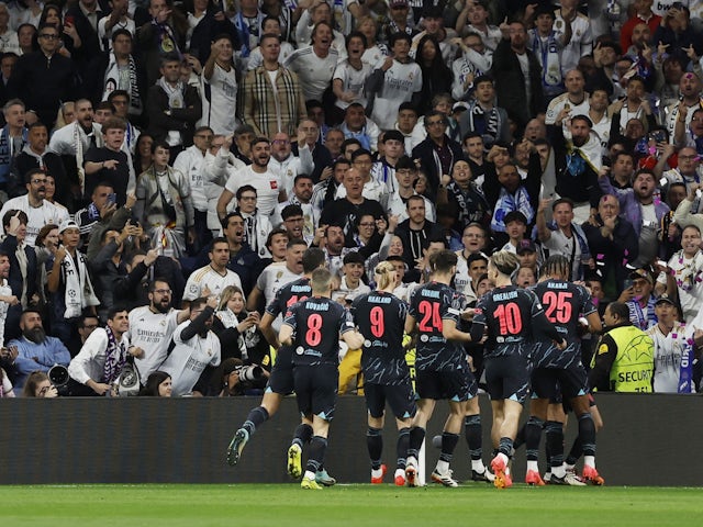 Manchester City players celebrate after Bernardo Silva scores their first goal on April 9, 2024