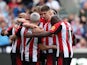  Brentford players celebrate after Sheffield United's Ollie Arblaster scores an own goal and their first goal on April 13, 2024