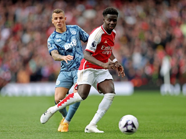 Aston Villa's Lucas Digne in action with Arsenal's Bukayo Saka on April 14, 2024