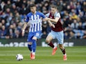 Brighton & Hove Albion's Jakub Moder in action with Burnley's Maxime Esteve on April 13, 2024