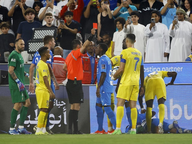 Al Nassr's Cristiano Ronaldo is shown a red card by referee Mohammed Al Hoaish after clashing with Al Hilal's Ali Al Bulayhi on April 9, 2024