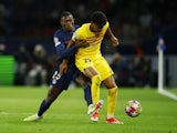 Paris Saint-Germain's Nuno Mendes in action with Barcelona's Lamine Yamal on April 10, 2024