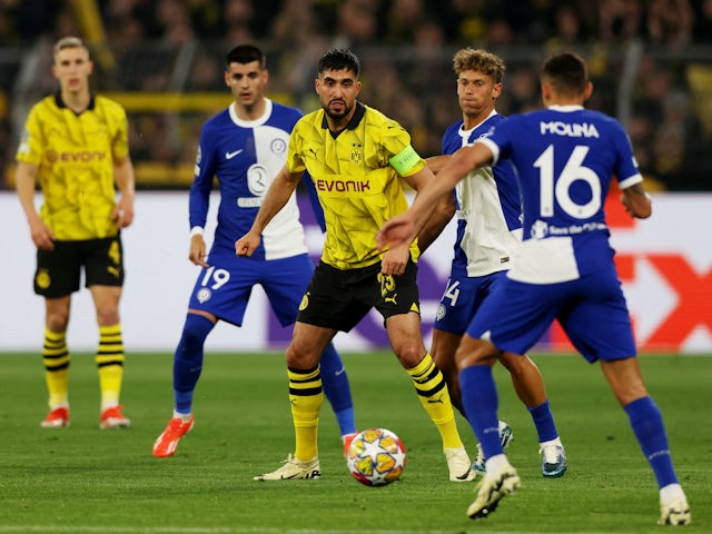 Atletico Madrid's Marcos Llorente in action with Borussia Dortmund's Emre Can on April 16, 2024