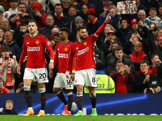 Manchester United's Bruno Fernandes celebrates scoring their third goal with Diogo Dalot and Amad Diallo on April 24, 2024