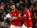 Manchester United's Bruno Fernandes celebrates scoring their second goal with Kobbie Mainoo on April 24, 2024