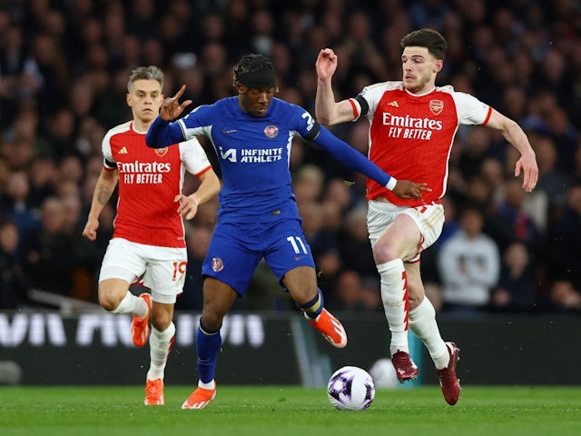 Chelsea's Noni Madueke in action with Arsenal's Declan Rice and Leandro Trossard on April 23, 2024