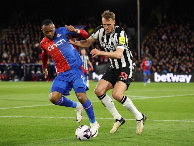 Newcastle United's Dan Burn in action with Crystal Palace's Jordan Ayew on April 24, 2024