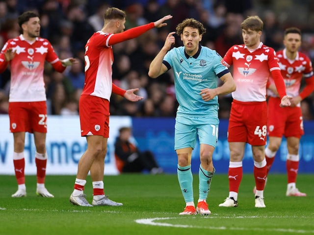 Barnsley players remonstrate as Bolton Wanderers' Dion Charles celebrates scoring their first goal on May 3, 2024