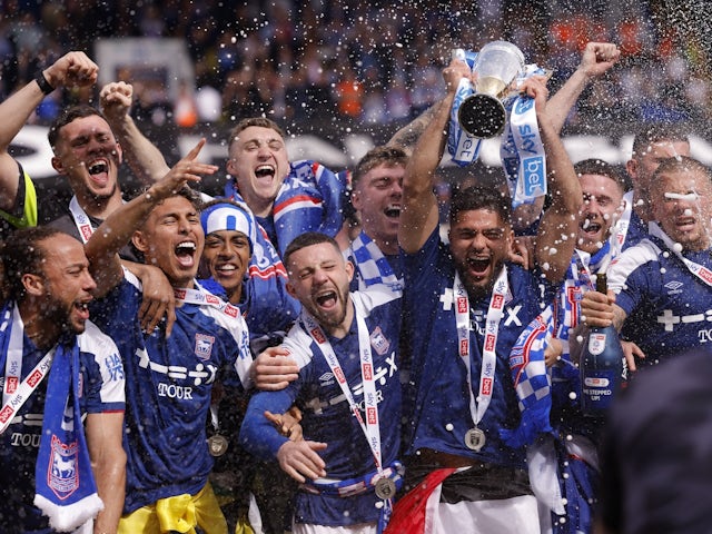 Ipswich Town players celebrate with a trophy and promotion to the Premier League on May 4, 2024