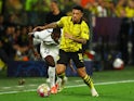 Paris Saint-Germain's Nuno Mendes in action with Borussia Dortmund's Jadon Sancho on May 1, 2024