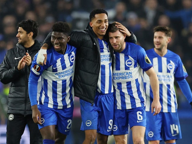 Brighton & Hove Albion's James Milner, Joao Pedro and Carlos Baleba celebrate after the match on December 14, 2023