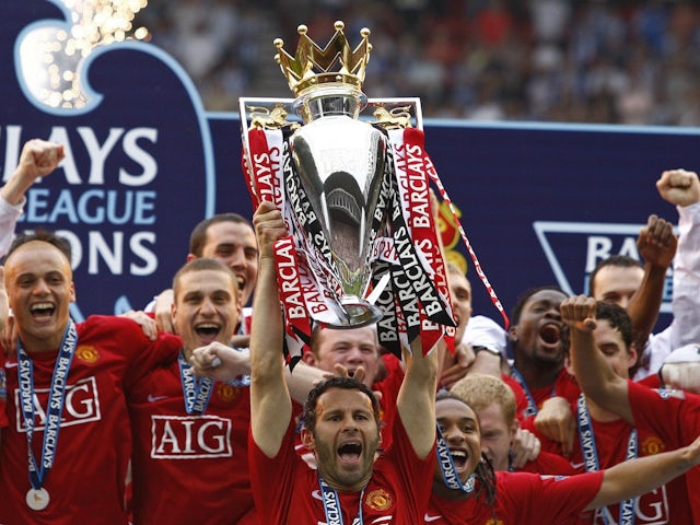 Manchester United's Ryan Giggs raises the Premier League trophy in 2008