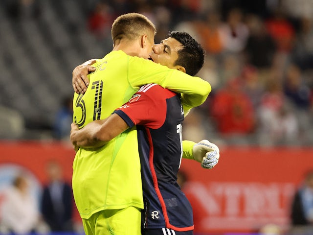 New England Revolution goalkeeper Aljaz Ivacic embraces his teammate Nick Lima