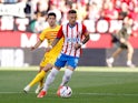 Girona's Aleix Garcia in action with Barcelona's Sergi Roberto on May 4, 2024