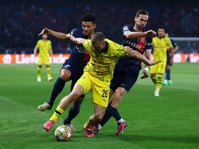 Borussia Dortmund's Julian Ryerson in action with Paris Saint-Germain's Goncalo Ramos and Fabian Ruiz on May 7, 2024