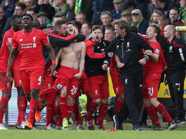 Adam Lallana celebrates with team mates and manager Jurgen Klopp after scoring the fifth goal for Liverpool on May 7, 2024