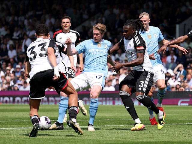 Manchester City's Kevin De Bruyne in action with Fulham's Antonee Robinson and Calvin Bassey on May 11, 2024