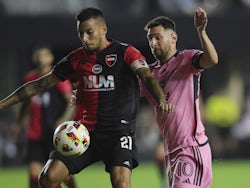 Leonel Vangioni of Newell's Old Boys shield the ball from Lionel Messi in a 2024 friendly