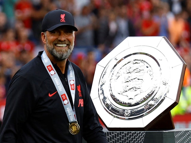 Liverpool manager Jurgen Klopp celebrates alongside the trophy after winning the Community Shield on July 30, 2022