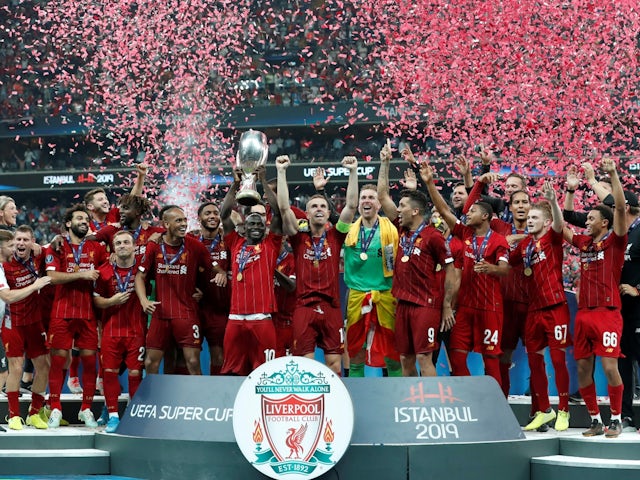 Liverpool's Sadio Mane lifts the trophy as he celebrates winning the UEFA Super Cup with teammates on August 14, 2019