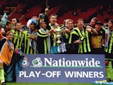 Manchester City players celebrate gaining promotion from the third tier after winning the playoff final on May 30, 1999