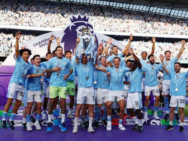 Manchester City's Kyle Walker and teammates celebrate with the trophy after winning the Premier League on May 19, 2024