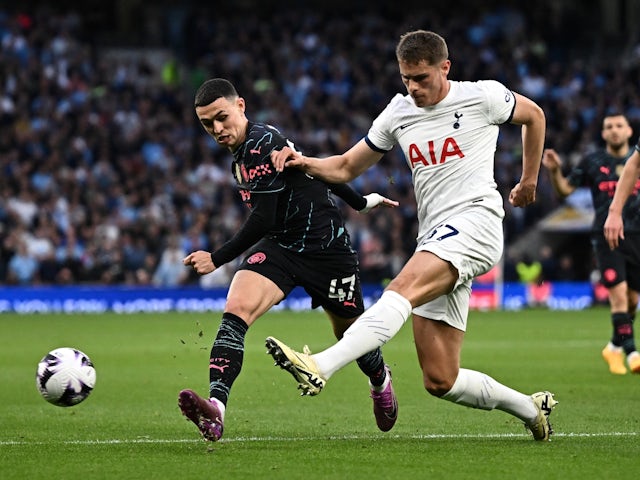 Manchester City's Phil Foden in action with Tottenham Hotspur's Micky van de Ven on May 14, 2024