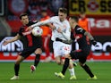Mainz 05's Brajan Gruda in action with Bayer Leverkusen's Alejandro Grimaldo and Jonas Hofmann on May 25, 2024