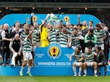 Celtic's Callum McGregor celebrates with teammates and the trophy after winning the Scottish Cup on May 25, 2024