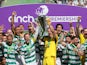 Celtic's Callum McGregor and Joe Hart lift the trophy with teammates after winning the Scottish Premiership on May 18, 2024