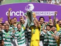 Celtic's Callum McGregor and Joe Hart lift the trophy with teammates after winning the Scottish Premiership on May 18, 2024