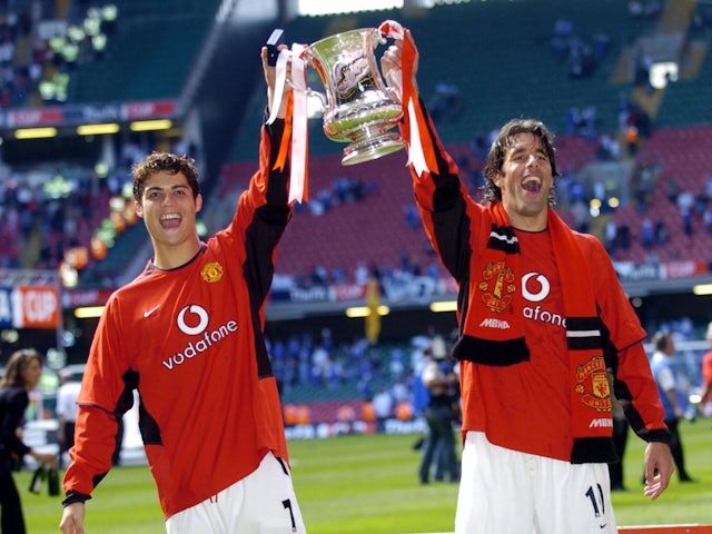 Manchester United's Cristiano Ronaldo and Ruud van Nistelrooy celebrate with the trophy after winning the FA Cup on May 22, 2004