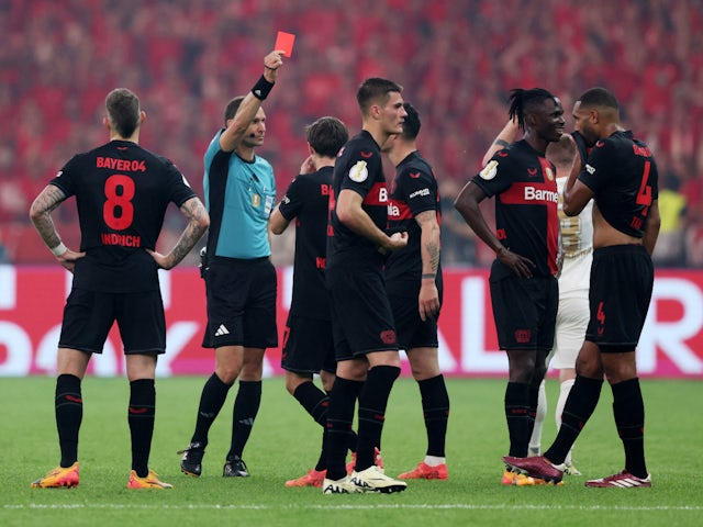 Bayer Leverkusen's Odilon Kossounou is shown a red card by referee Bastian Dankert on May 25, 2024