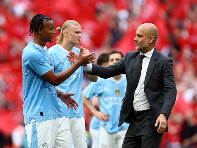 Manchester City manager Pep Guardiola and Manuel Akanji look dejected after the match on May 25, 2024