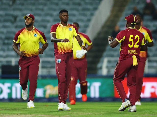 West Indies' Alzarri Joseph celebrates with teammates after taking a wicket on March 28, 2023