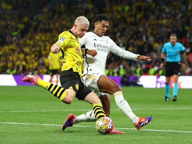 Borussia Dortmund's Julian Ryerson in action with Real Madrid's Jude Bellingham on June 1, 2024