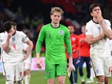 England's Jordan Pickford and Harry Maguire look dejected after the match on July 11, 2021