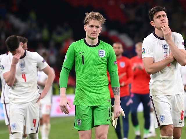 England's Jordan Pickford and Harry Maguire look dejected after the match on July 11, 2021