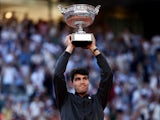 Carlos Alcaraz poses with the trophy after winning the French Open on June 9, 2024